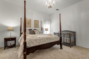 Bedroom with a king size bed, private sink and walk-in closet.