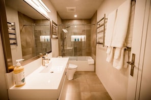 Bathroom with deep soaking tub and heated floor,  Toto Washlet and towel warmer