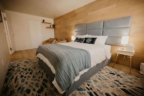 Bedroom with a queen size bed and a walk-in closet.