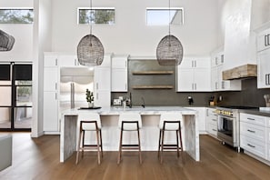 Welcome to your dream kitchen! This spacious area features a stunning center island, perfect for meal prep and entertaining. Pull up a seat on one of the three stylish stools and let's get cooking!