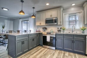 Cook in style in our modern open kitchen, blending sleek design with functional elegance.