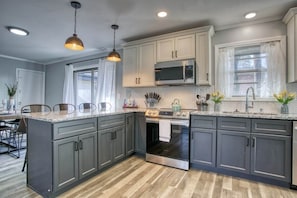 Cook in style in our modern open kitchen, blending sleek design with functional elegance.