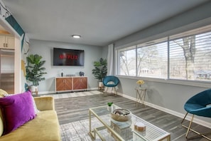Catch your favorite shows on the Smart TV, set in a spacious living area perfect for relaxing.