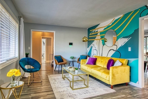 Welcome to Rocksteady Retreat—where art comes alive in a vibrant and stylish living room.