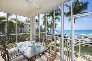 Enjoy meals with ocean views on the screened patio.