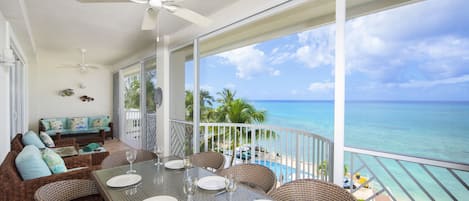 Fully furnished screened balcony with elevated oceanfront views. 