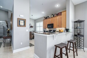 The kitchen features additional seating at the counter.