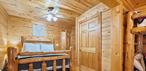 This bedroom features a double bed and two twin beds, perfect for a family or group.