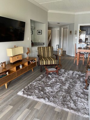 Living room; wet bar in background.