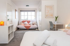 This top level bedroom is a beautiful private retreat. It has its own ensuite and a sofa bed. Chill near the window and bask in the natural light that fills the room or look out and enjoy the city scape.