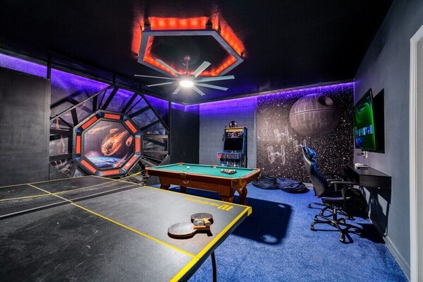An extravagant entertainment space for the whole family! Star Wars themed game room can be found downstairs.