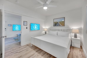 The bedroom features a king-sized bed and a wall-mounted Smart TV.