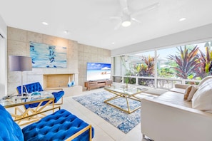 This living in Suite Two area has a 75-inch flat screen Smart TV and a leather queen pullout sofa.