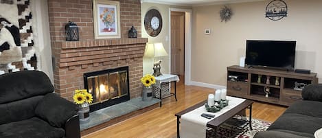 Living room with fireplace, looking from front entrance