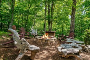 A private wood burning fire pit on the 1.7 acres of private grounds that also features a running creek and pond, swings, charming pathways and a horseshoe game