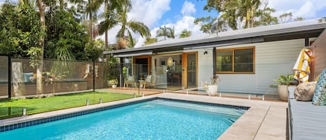 Large glass fenced pool with lounge