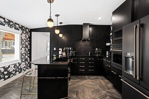 Spacious Matte Black Kitchen with GE Cafe appliances