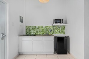 The kitchen is fully stocked with essential amenities for cooking and dining, such as a stove, oven, refrigerator, microwave, and other necessary appliances.