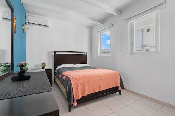 Relax luxuriously in this sophisticated bedroom adorned with contemporary artworks, harmonized by the soothing blue and white hues of the walls.