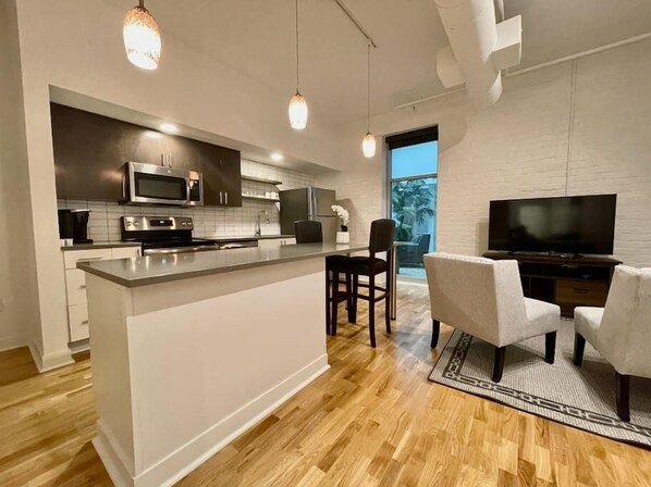 Living room and large eat-in kitchen island.