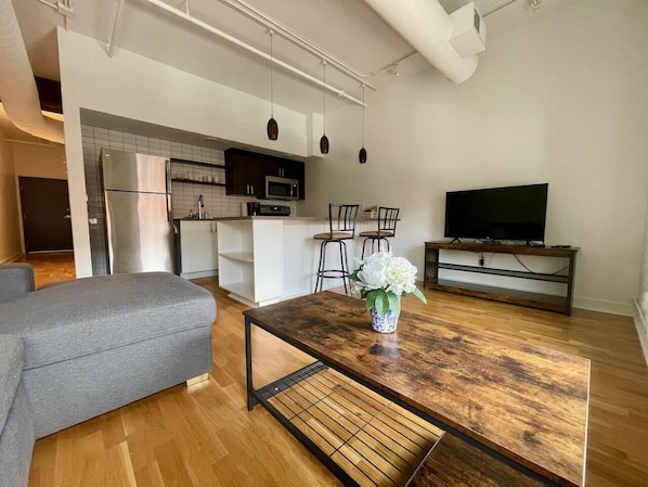 Living room area with sleeper sofa, large island and fully equipped kitchen
