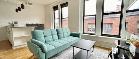 Living room space with tv and futon sofa