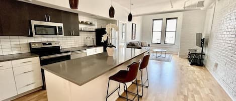 Open floor plan with large eat-in kitchen island and living room space.