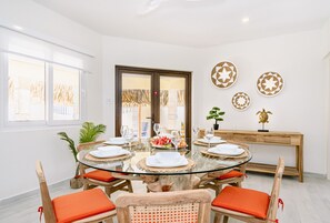 Radiant dinning area of the Villa in Noord, Aruba - 6 Persons Beautiful Dinning - Private dinning space with elite decor - Availability of TV and Netflix - Soul enhancing space - Large windows with beautiful outside view