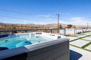 Bath in the 2022 7 person Hot Spring Rhythm hot tub.