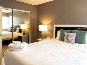  This bedroom comes with a queen-sized bed, workplace area, & 2 bed-side tables