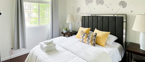 This bedroom comes w/ a queen-sized bed, comfy chair & 2 bed-side tables w/ lamp