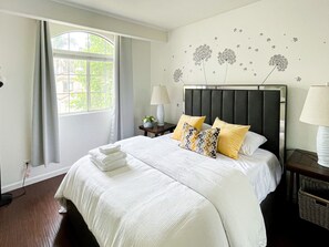 This bedroom comes w/ a queen-sized bed, comfy chair & 2 bed-side tables w/ lamp
