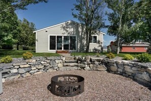 Back entry to the home with family fire pit.