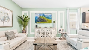 Spacious living room area with cozy sofa, perfect for family reunion