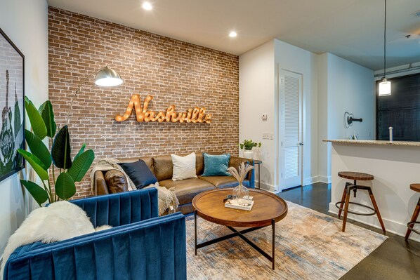 Urban style living room with designer furnishings and flat screen TV.