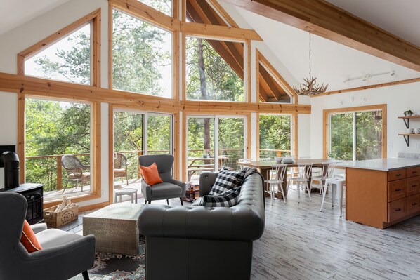 Main floor open concept living room + dining room with views of the deck.