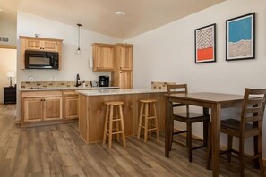 Dining area with mini kitchenette. Exact unit will be assigned upon arrival. Views, colors and decor may vary.