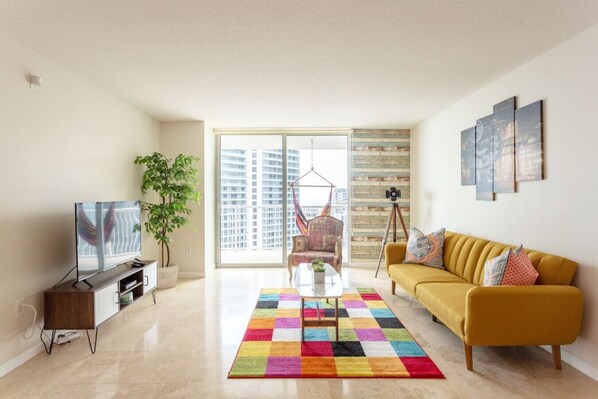 Pristine living room featuring a sofa bed and Smart TV