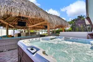 Heated Pool, hot tub, Tiki Huts and outdoor kitchen with plenty of seating options in this wonderfully social private yard