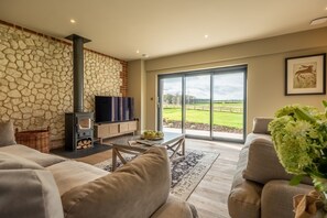 Hayloft, Burnham Market:  Sitting room with wood burning stove
