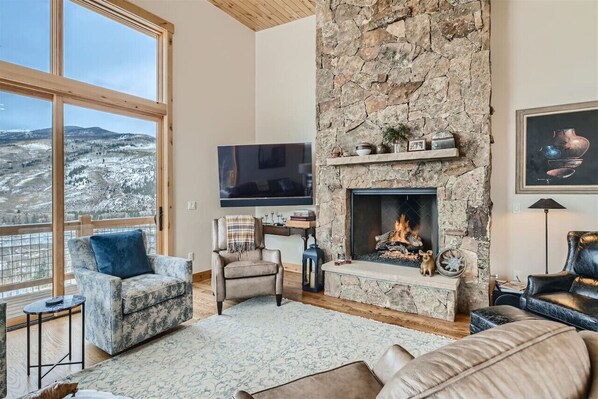 Open plan living room with gas fireplace and amazing mountain views