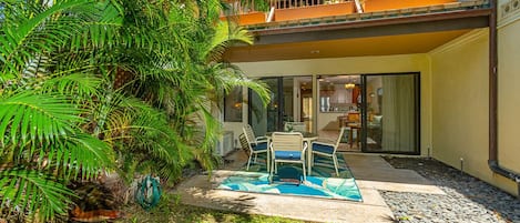 Private lanai surrounded by tropical scenery & plush green grass
