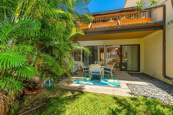 Private lanai surrounded by tropical scenery & plush green grass