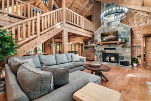 The generous living space offers a comfortable couch, perfect for curling up with a book or hanging out for family movie night. The cabin's open layout provides plenty of space for your group to gather!