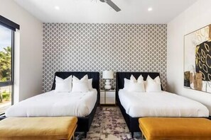 Double queen primary bedroom with en suite bathroom and full walk-in closet