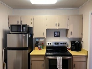 Fully equipped kitchen with modern appliances, including a microwave and stove.
