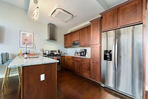 Well-equipped kitchen with granite countertops.