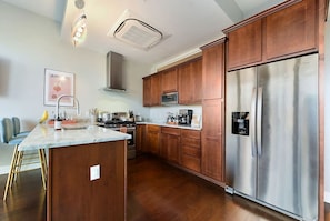 Well-equipped kitchen with granite countertops.