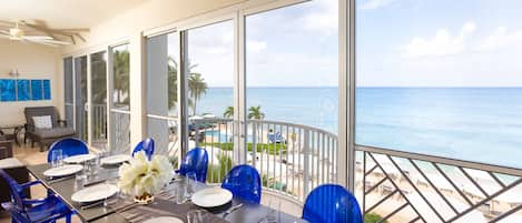 All photos are recent as of January 2023. Enjoy dinner with ocean views from this unit's screened balcony.