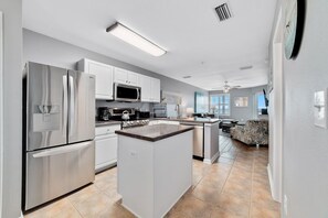 The kitchen is equipped with stainless steel appliances which enhance the luxe aesthetic of the home.